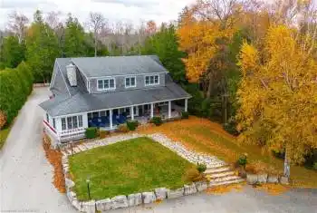 View of front of home featuring a porch, front yard and circular drive