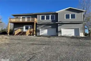 Front facade featuring a balcony and a garage