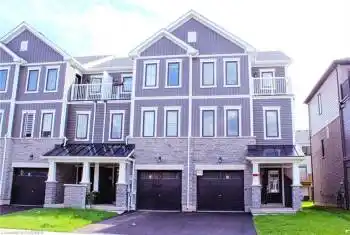 View of front facade with a balcony and a garage