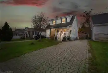 View of front facade featuring a yard and covered porch