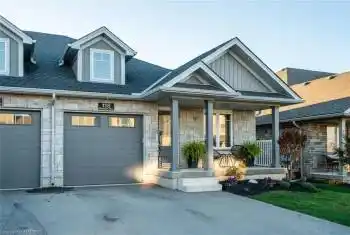 View of front of house featuring a garage and a porch