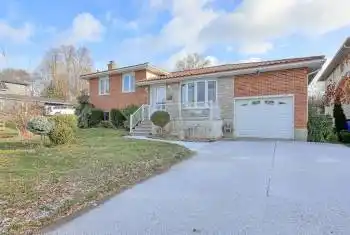 View of front of home with a front yard and a garage