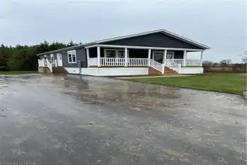 View of front of house featuring covered porch and a front yard