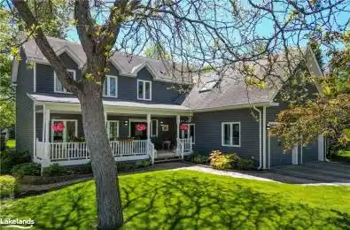 View of front of home with a garage, covered porch, and a front lawn