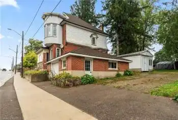 View of side of property featuring a storage shed