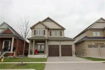 Craftsman inspired home featuring a garage and a front yard