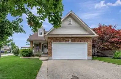View of front facade featuring a garage, covered porch, and a front lawn